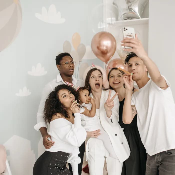 Friends crowding into a phone camera for a group photo