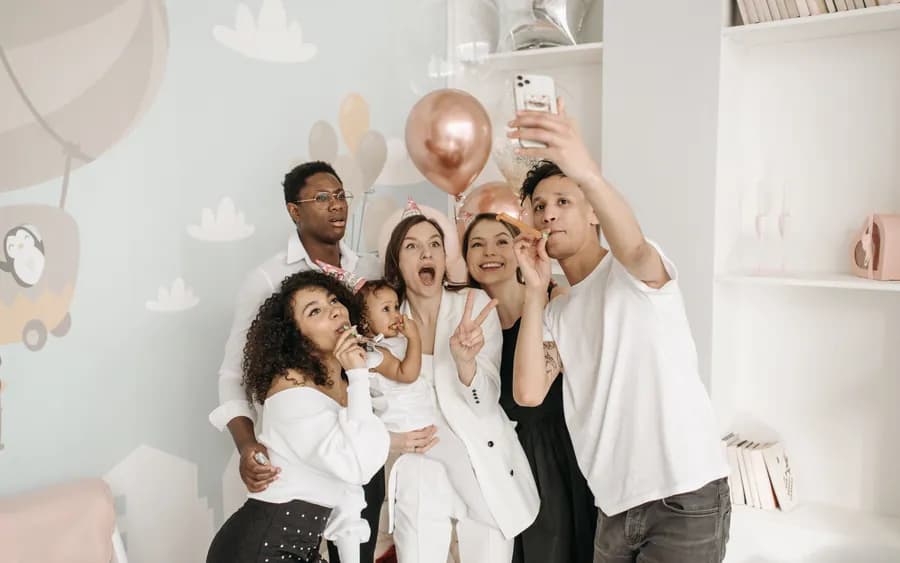 Friends crowding into a phone camera for a group photo