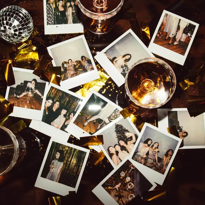 Polaroid photographs scattered over gold confetti after a party